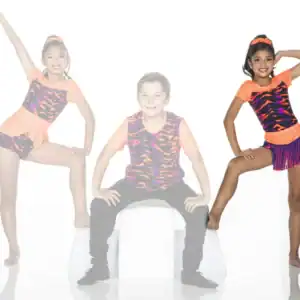 Three young dancers posing in colorful orange and patterned costumes