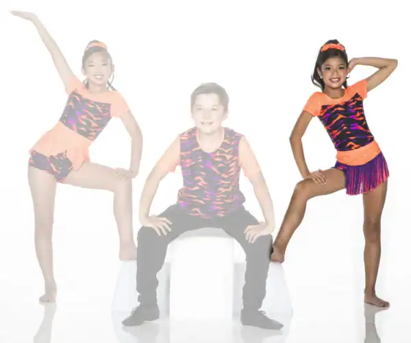 Three young dancers posing in colorful orange and patterned costumes