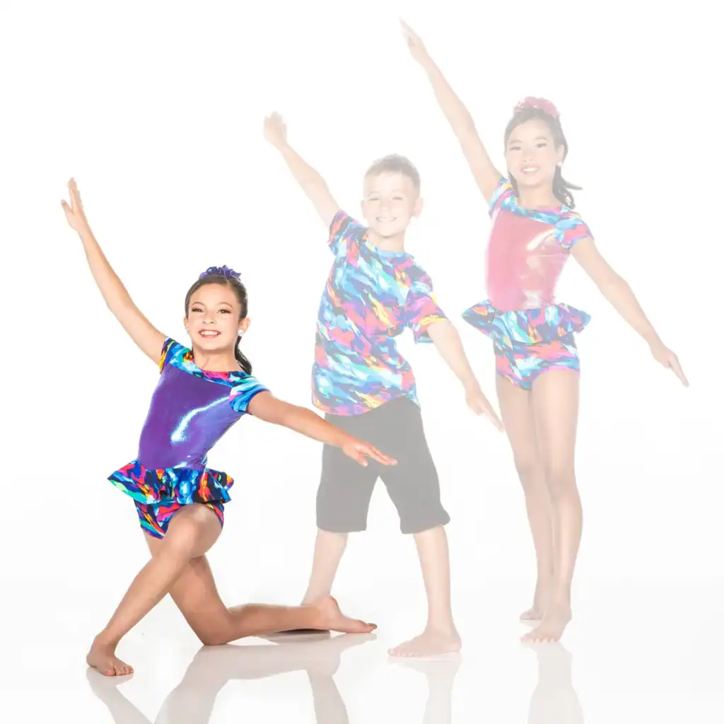 Three children posing in colorful dance costumes