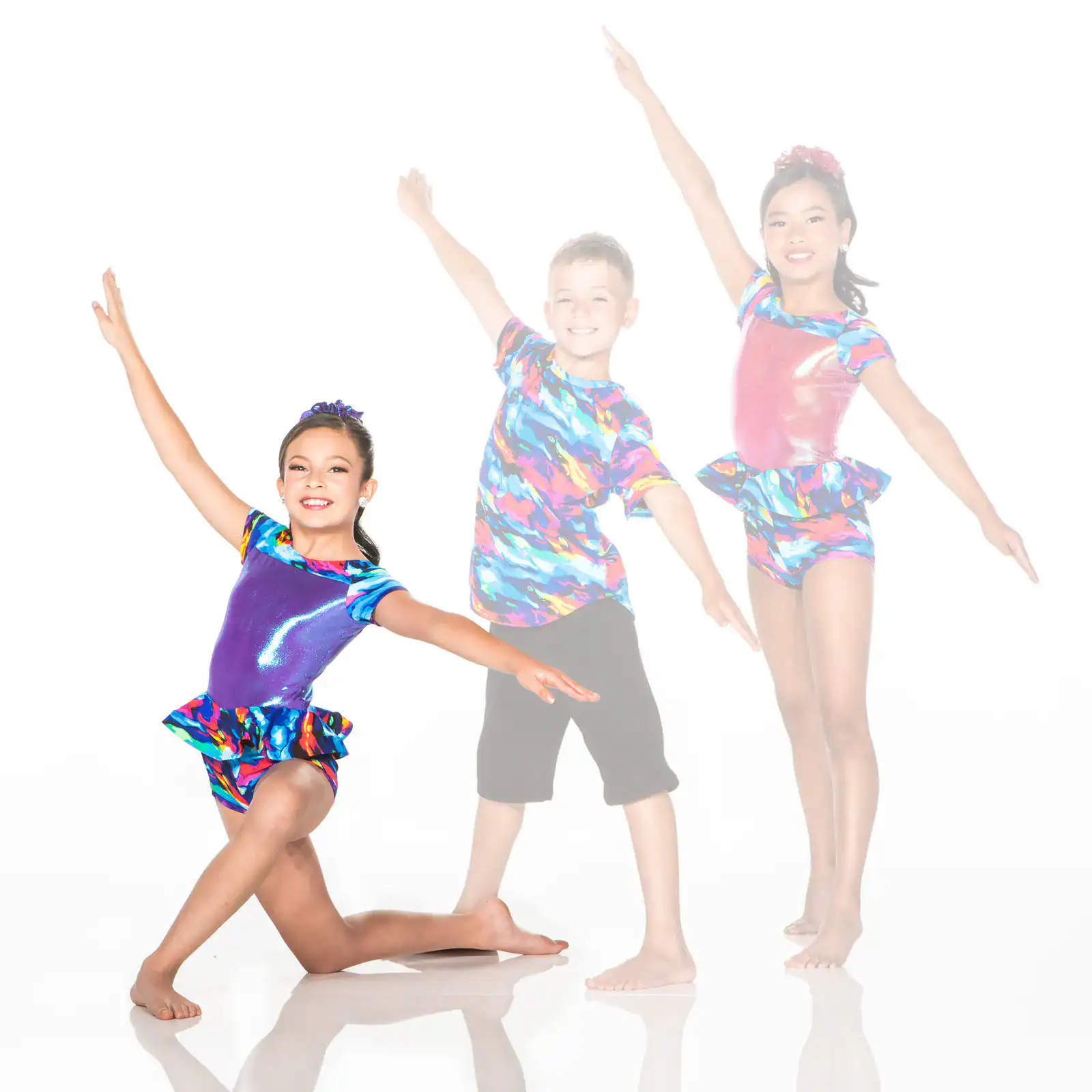 Three children posing in colorful dance costumes