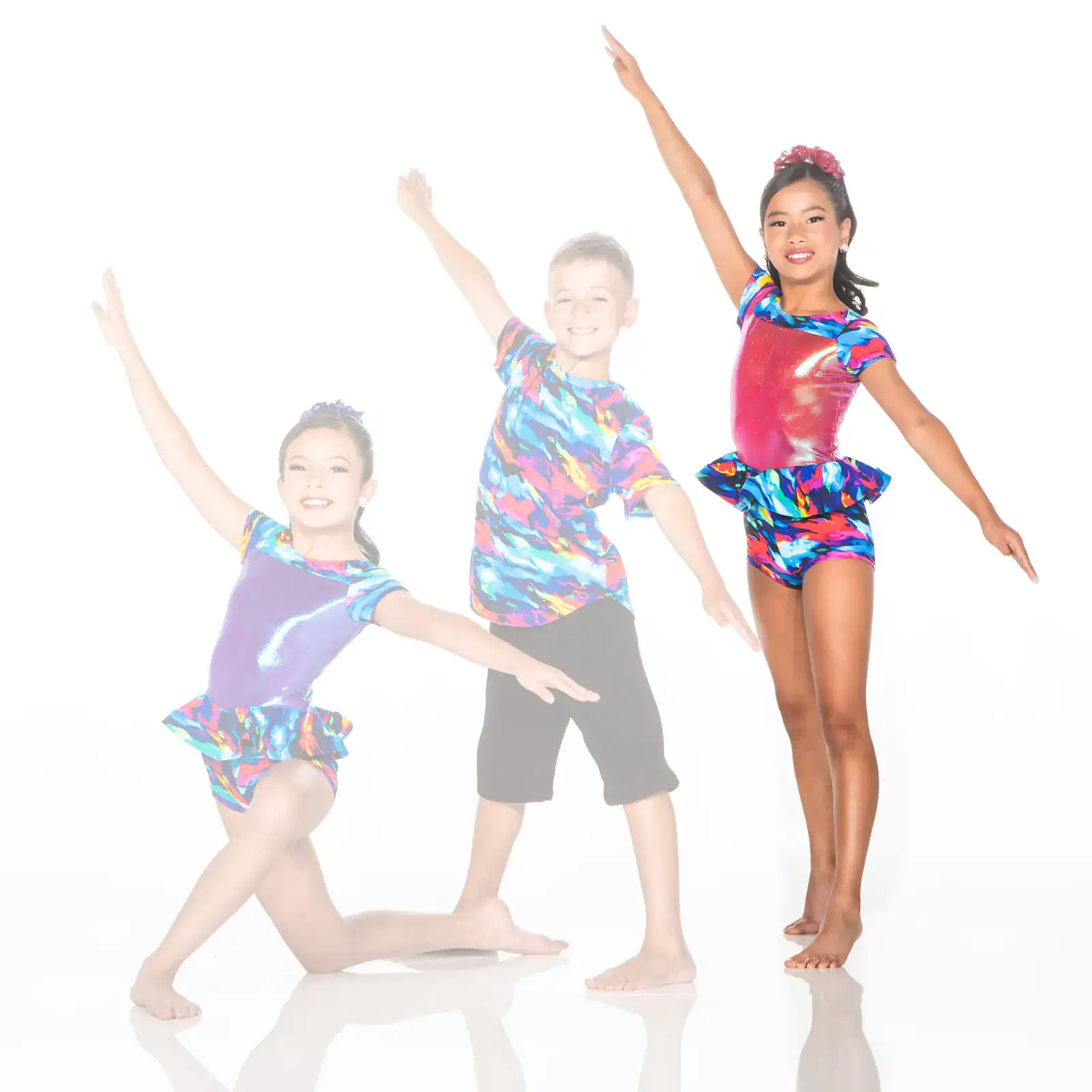 Three young dancers in colorful costumes posing against white background