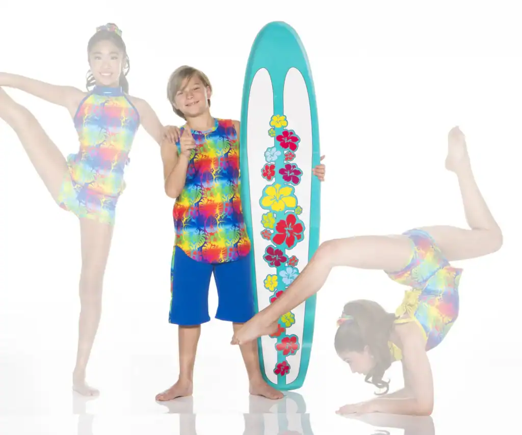 Children pose with floral surfboard in colorful swimwear
