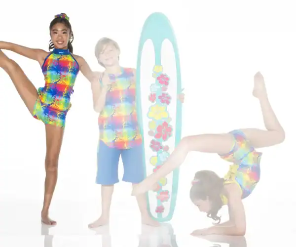 Children wearing colorful tropical outfits pose with surfboard