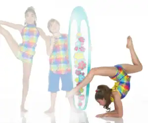 Children in tropical dancewear pose with floral surfboard