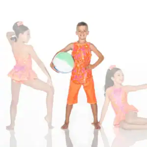 Three children modeling bright floral swimwear with beach ball
