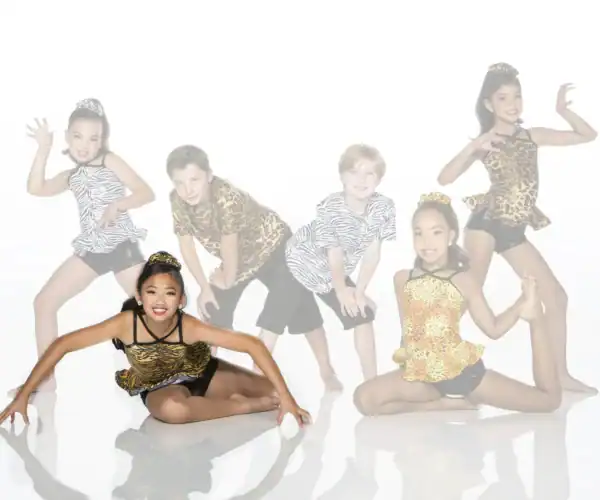 Six children pose in animal-print dance costumes.