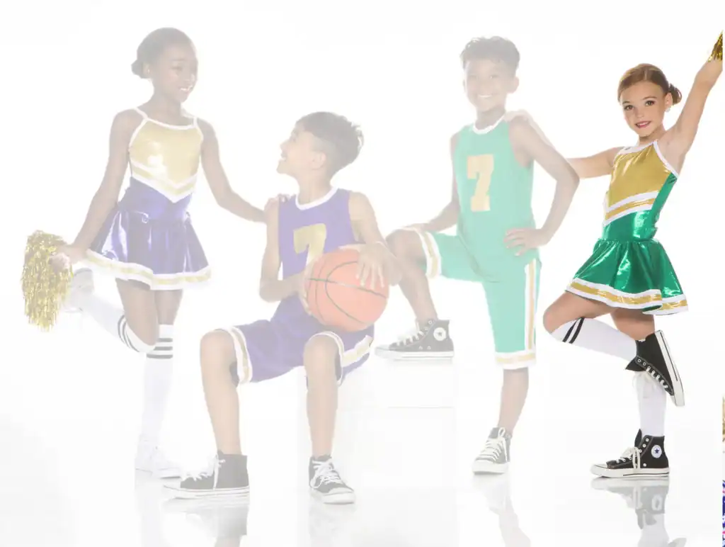 Four children in basketball uniforms and cheerleading outfits
