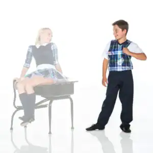 Two children wearing coordinated plaid school uniforms