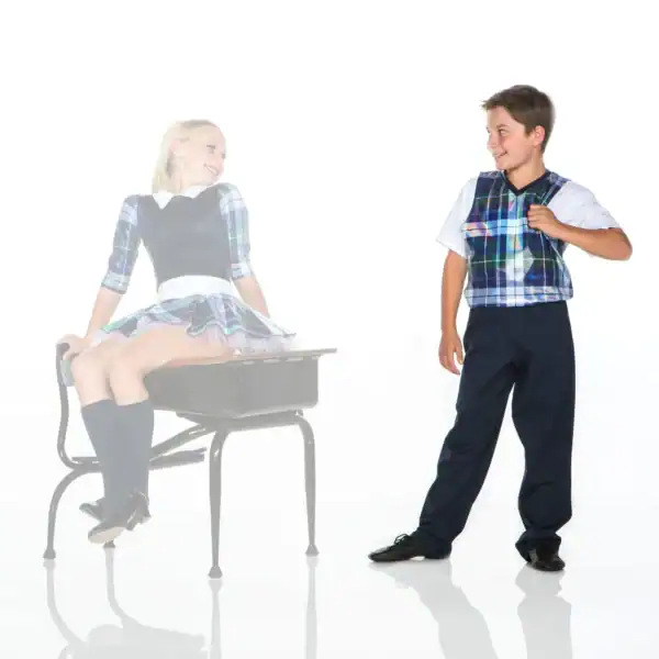 Two children wearing coordinated plaid school uniforms