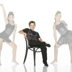 Three young dancers in colorful costumes posing in studio
