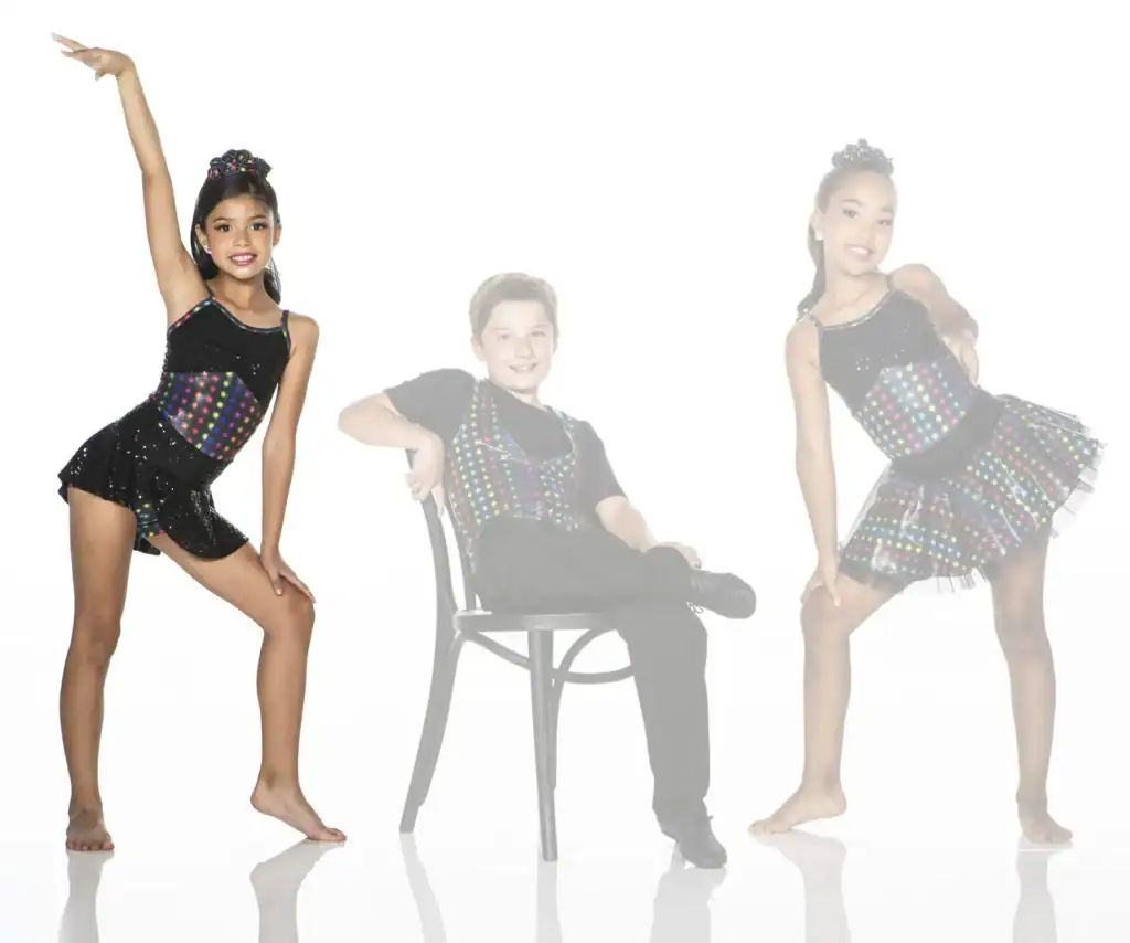 Three young dancers pose in colorful black costumes.