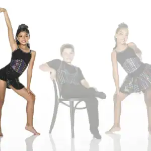 Three young dancers pose in colorful black costumes.
