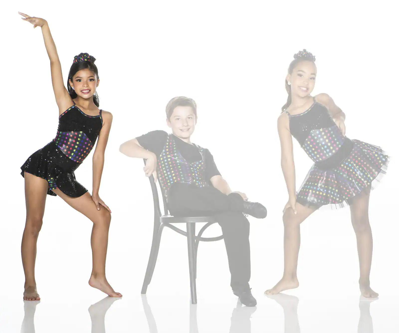 Three young dancers pose in colorful black costumes.