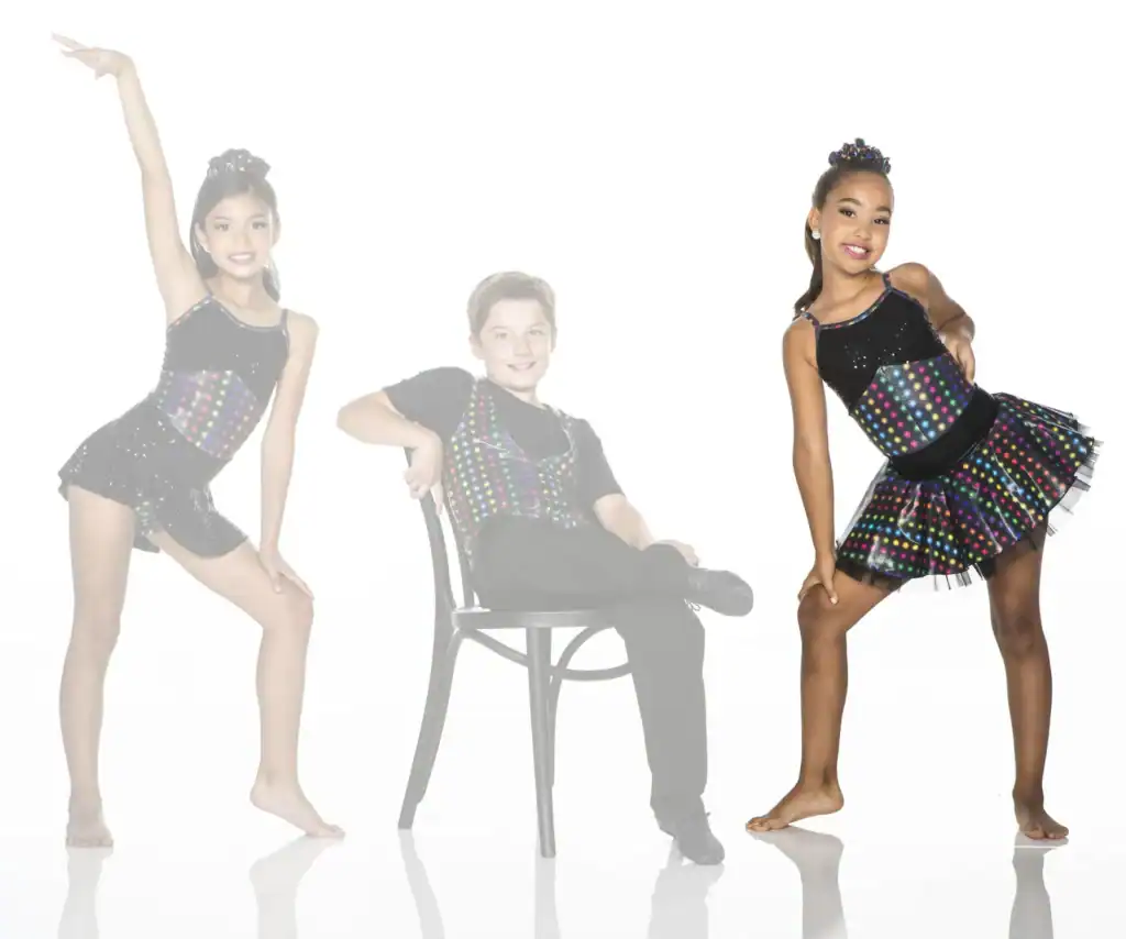 Three young dancers in colorful polka-dot costumes posing