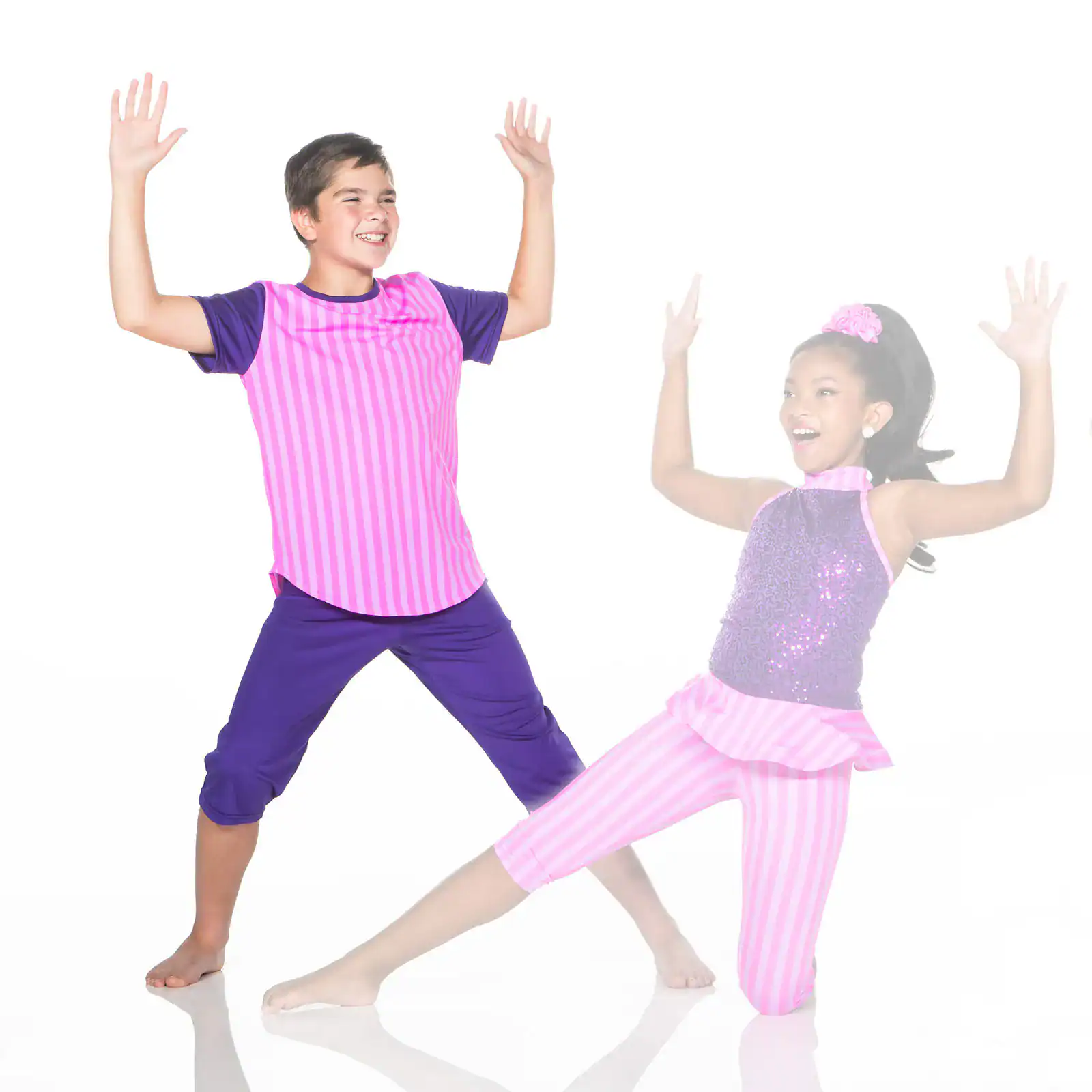 Two children in colorful costumes dancing with raised arms