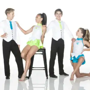 Four children wearing colorful dance costumes pose in studio.