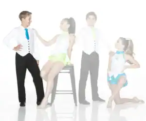 Four young dancers pose in colorful costumes against white background.