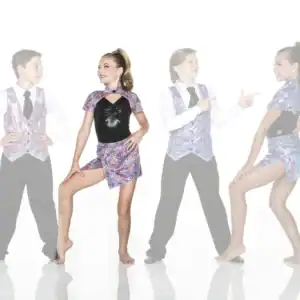 Four young dancers wearing colorful mosaic-patterned costumes pose together.