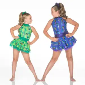 Two young dancers wearing colorful patterned costumes pose together.