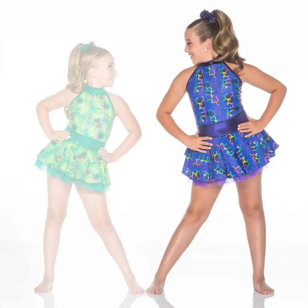 Two girls wearing colorful patterned dance costumes pose together.