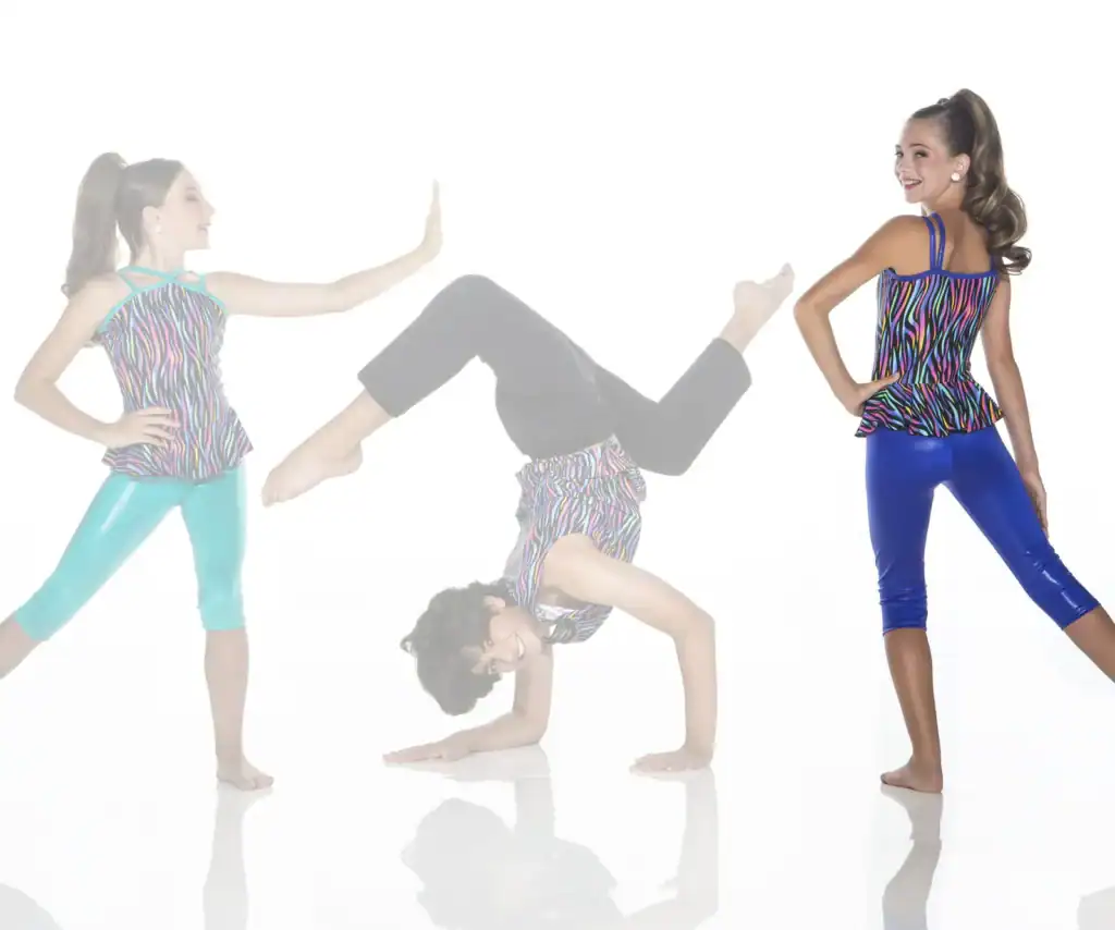 Three young dancers in colorful zebra-print outfits posing