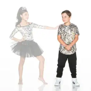 Two children wearing matching metallic patterned outfits pose together.