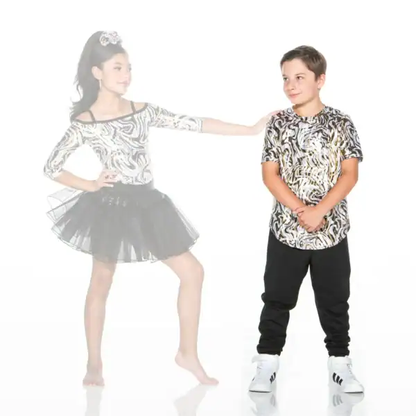 Two children wearing matching metallic patterned outfits pose together.