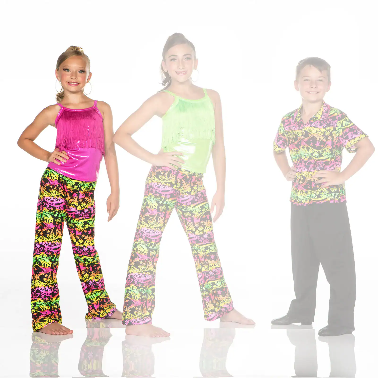 Three children modeling colorful dance costumes against white background