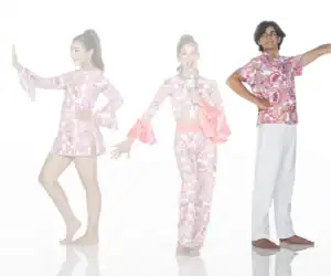 Three children modeling colorful paisley dance costumes on white background