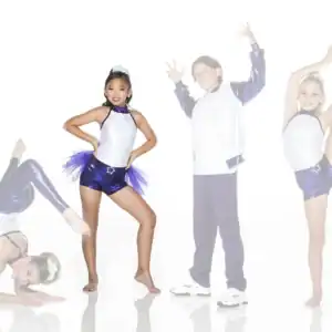 Four young dancers posing in purple and white costumes