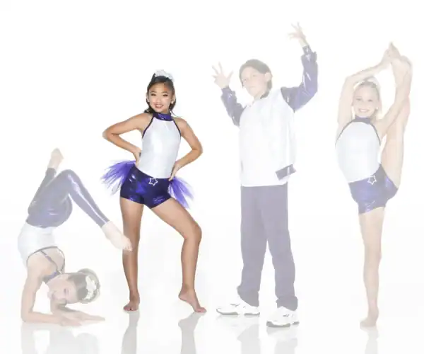 Four young dancers posing in purple and white costumes