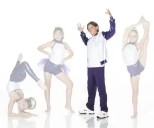 Four young dancers posing in purple and white costumes