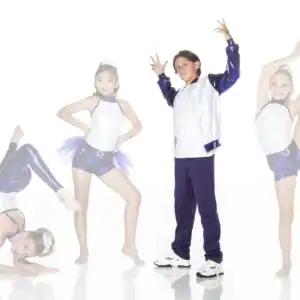 Four young dancers posing in purple and white costumes