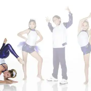 Four young dancers pose in purple and white costumes.