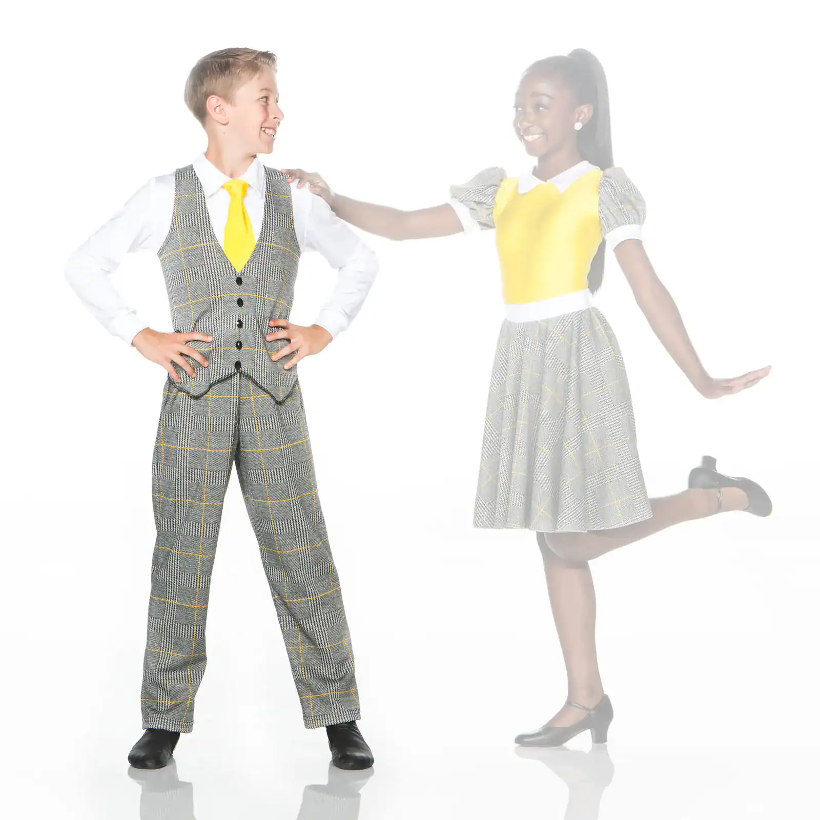 Two children wearing coordinated gray plaid and yellow outfits