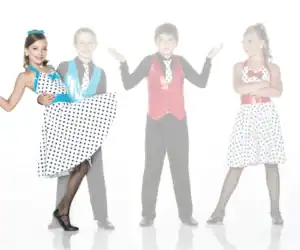 Four children in colorful polka-dot dance costumes