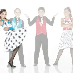 Four children in colorful polka-dot dance costumes