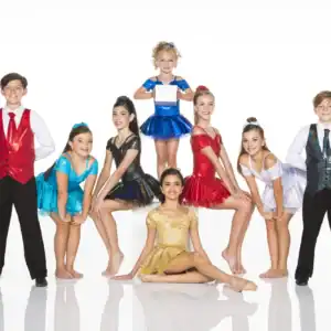 Youth dance team posing in colorful costumes