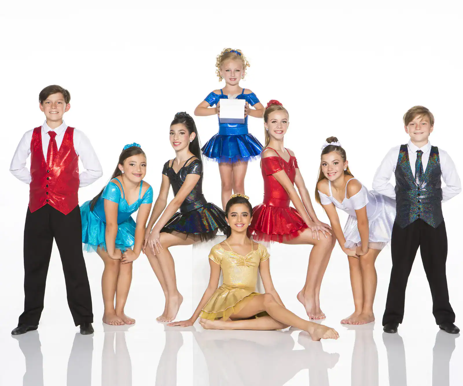 Youth dance team posing in colorful costumes