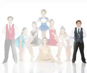 Young dancers in colorful costumes posing against a white background