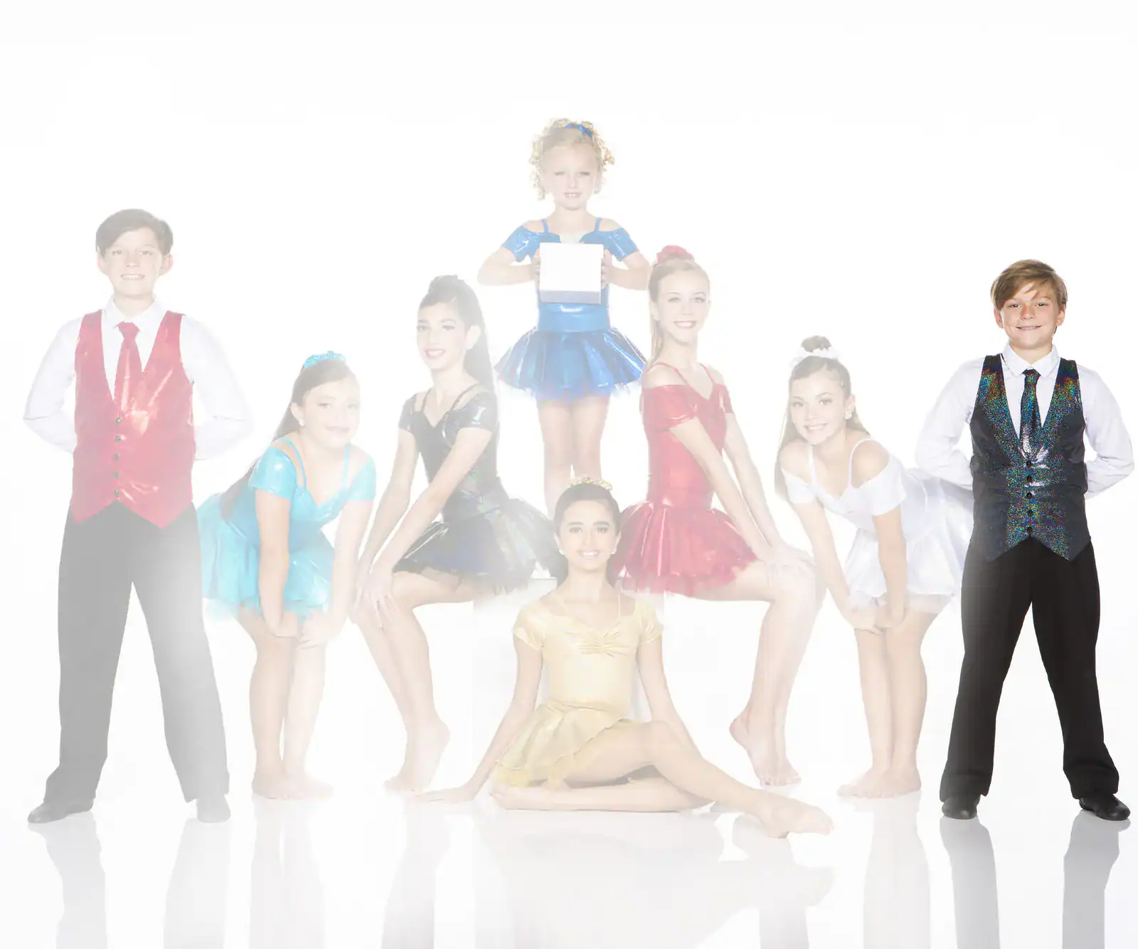 Young dancers in colorful costumes posing against a white background