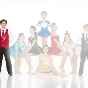 Young dancers in colorful costumes pose for a group photo.