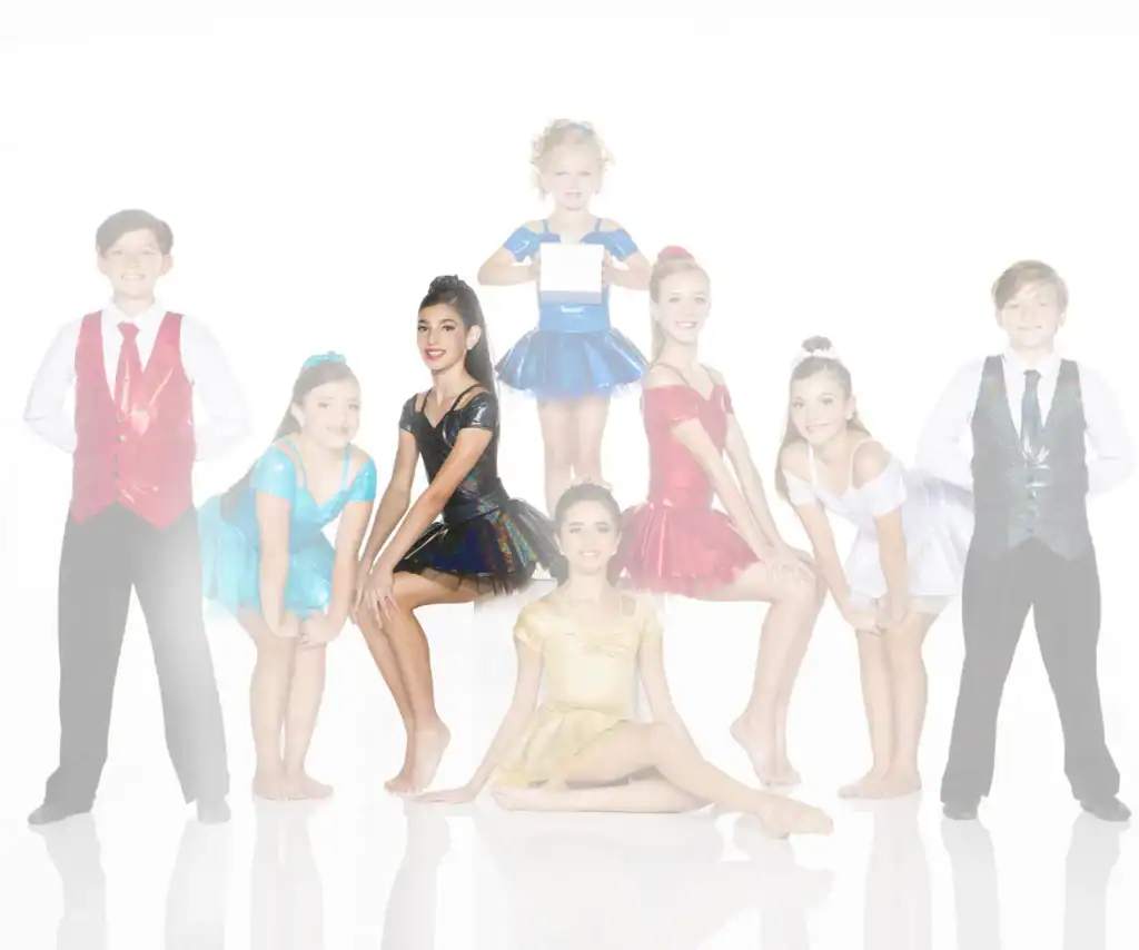 Eight young dancers pose in colorful costumes against white background.