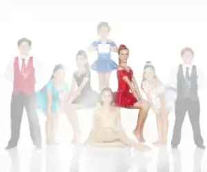 Young dancers posing in colorful costumes against white background