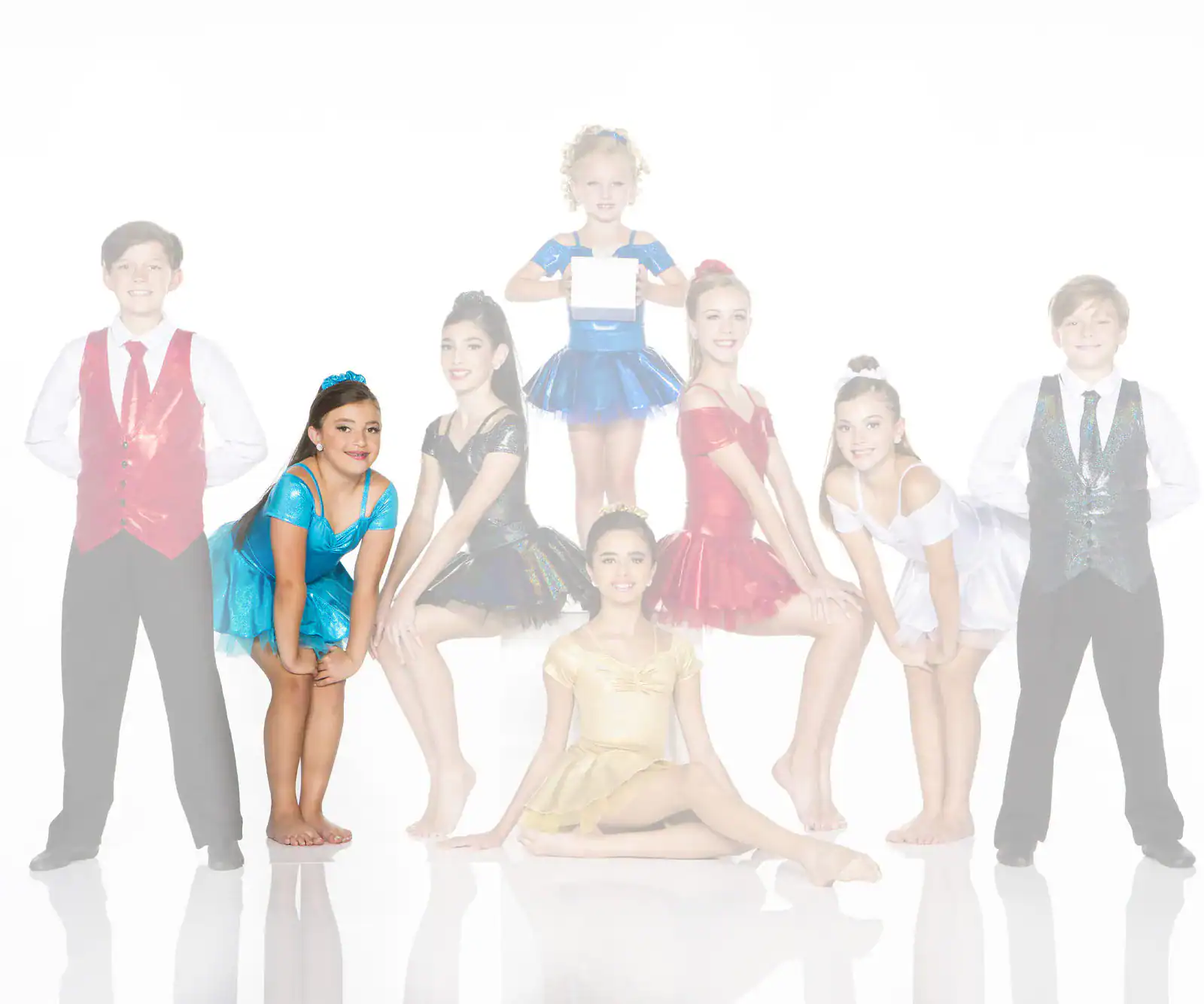 Young dancers in colorful costumes posing against a white background