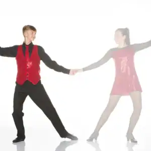 Two dancers in red costumes holding hands on white background