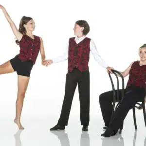 Three performers wearing red patterned vests pose in studio