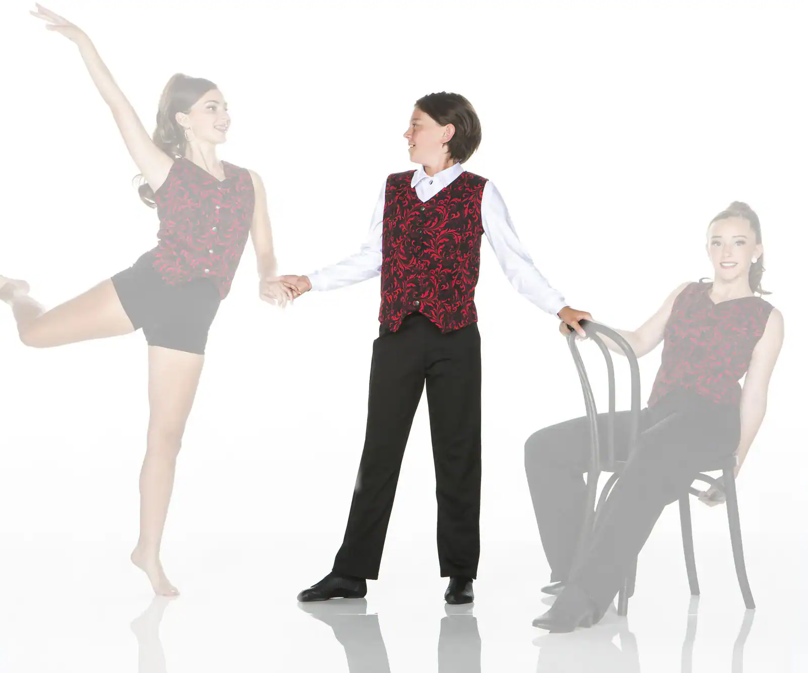 Dancers in matching red vests pose beside chair