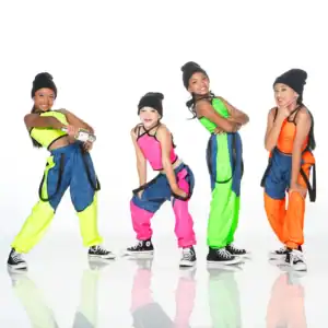 Four young dancers in neon hip-hop outfits posing together