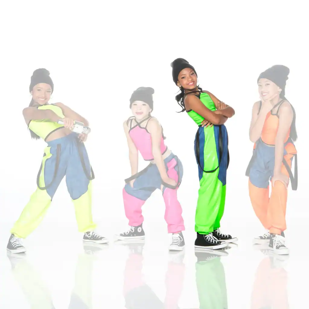 Four girls in colorful dance outfits posing in a studio